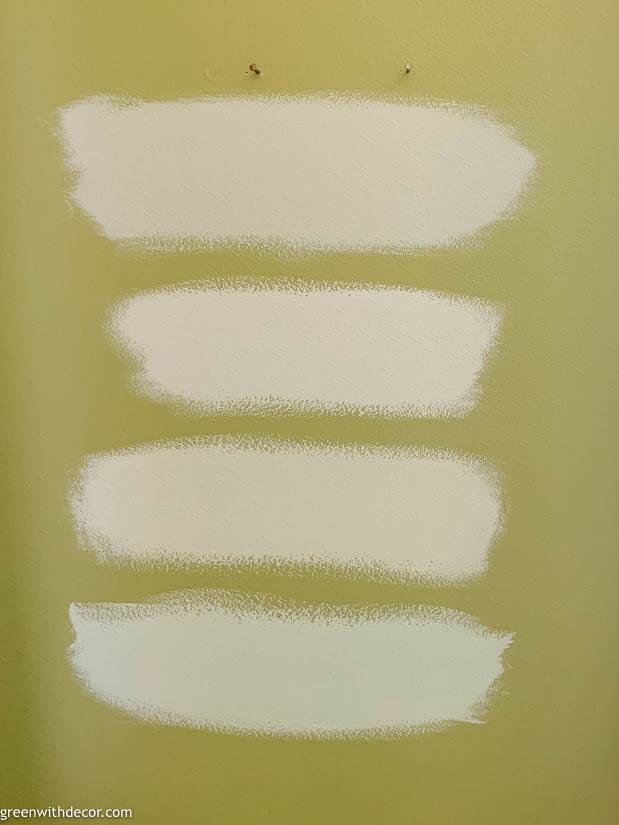 Blue paint samples on a green wall - how to pick paint colors