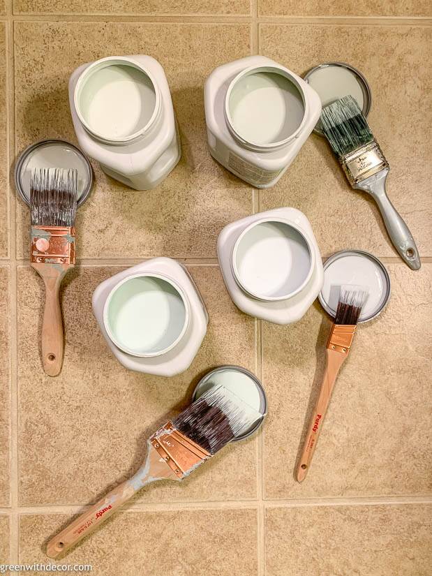 Paint sample jars of Sherwin Williams' Sea Salt, Topsail, Opaline and Dewey