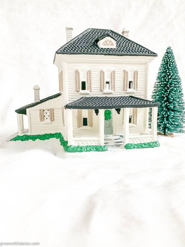 White painted Christmas village house with black roof and tan shutters