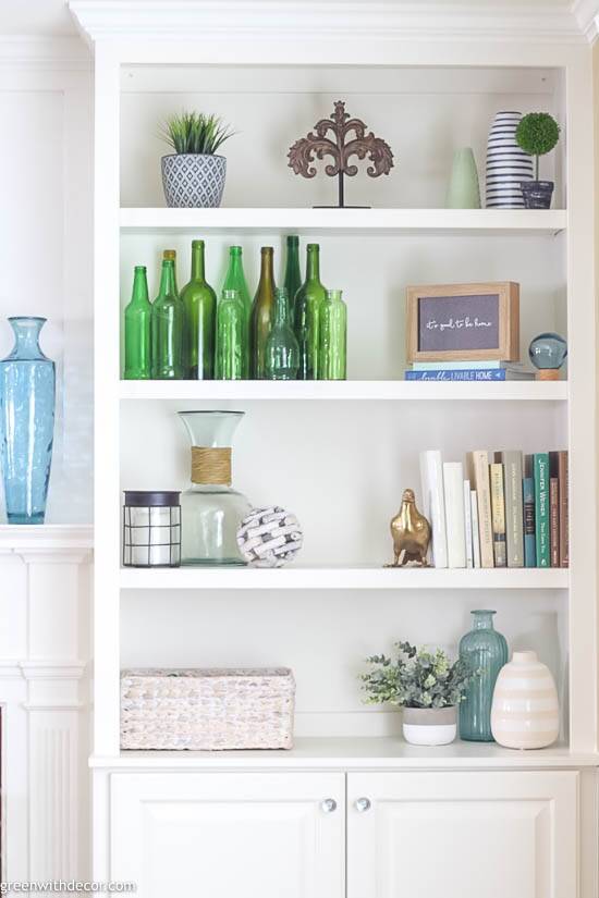 Bookshelf decorating ideas including green wine bottles, books and vases