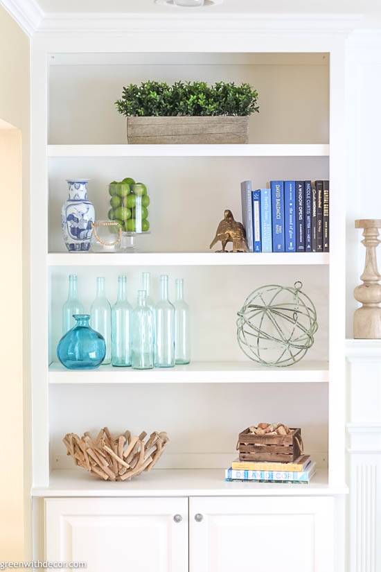 Bookshelf decorating ideas with coastal, glass and wood touches