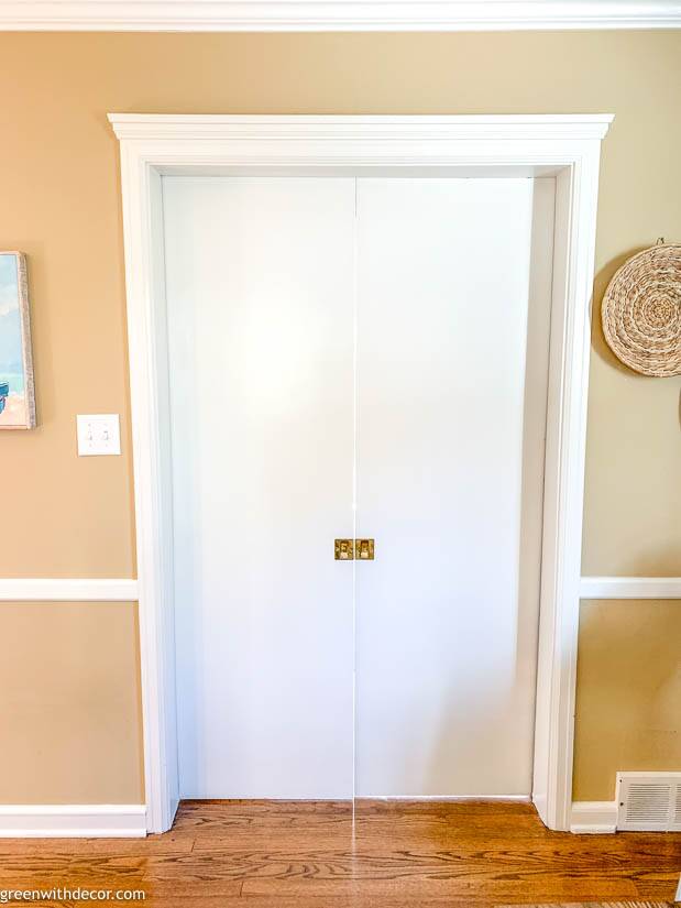 White pocket doors painted white near coastal artwork