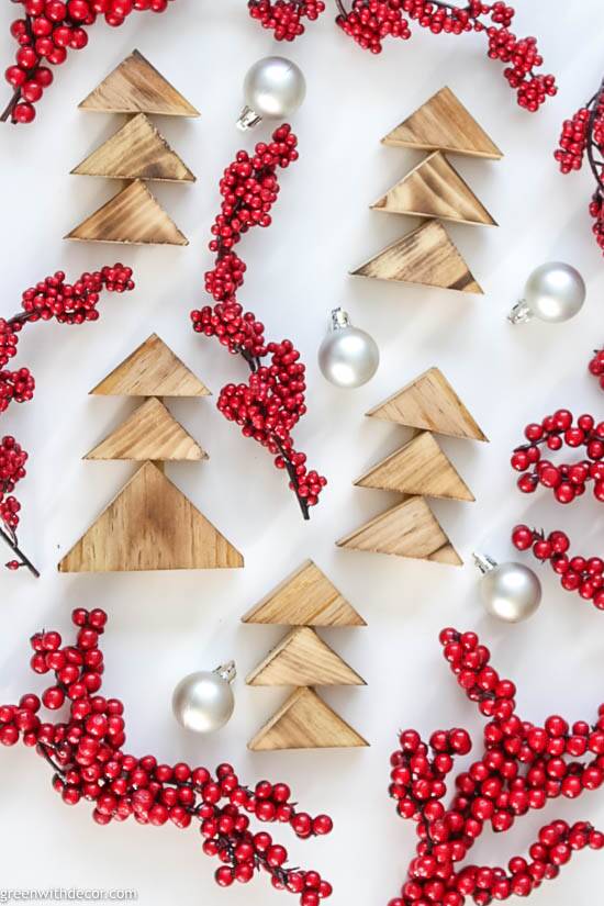 Burned wood DIY Christmas trees with red berries and silver ornaments