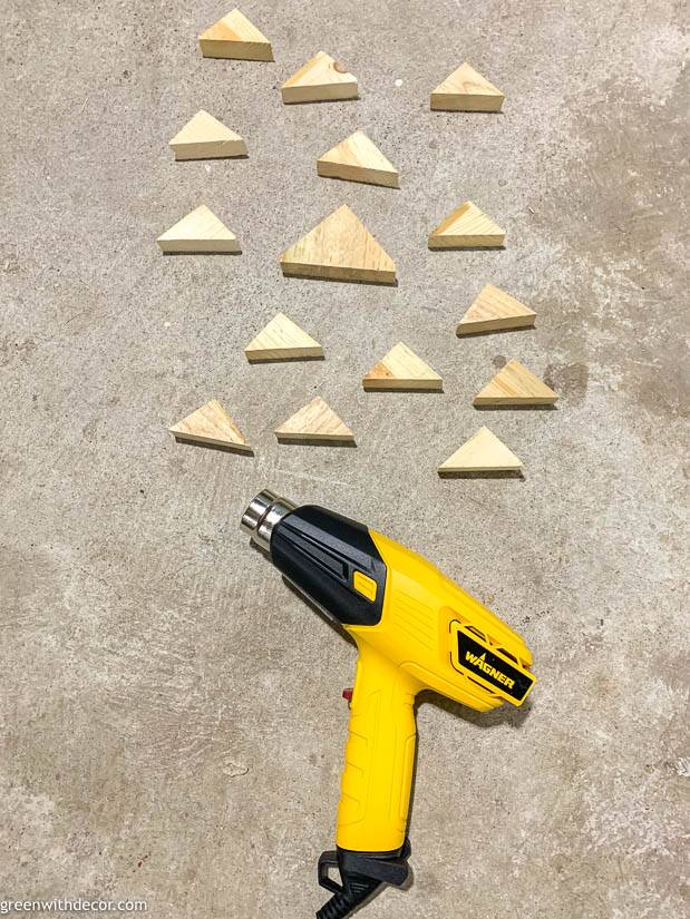 A Wagner heat gun near wood triangle pieces used for DIY Christmas trees
