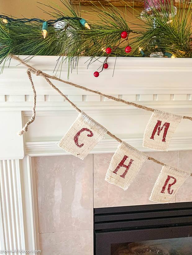 A DIY Christmas banner tied on a white mantel