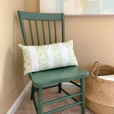 Dark green painted chair near tan wall