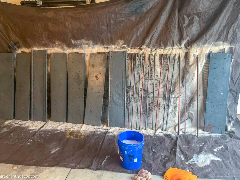 Bucket near old garage shelving before painting