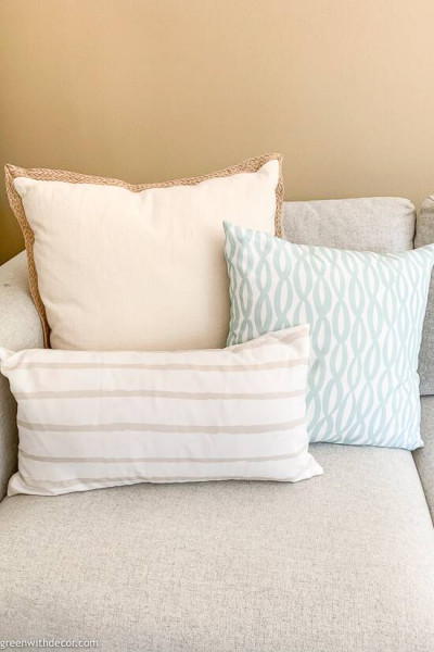 Mix and matched throw pillows on a gray couch