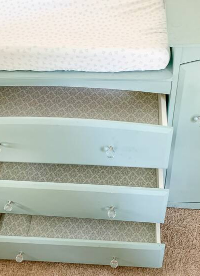 Blue dresser with pretty drawer liners