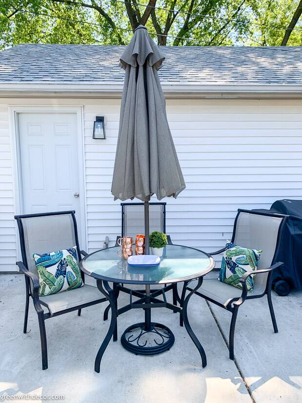 A patio table near white siding