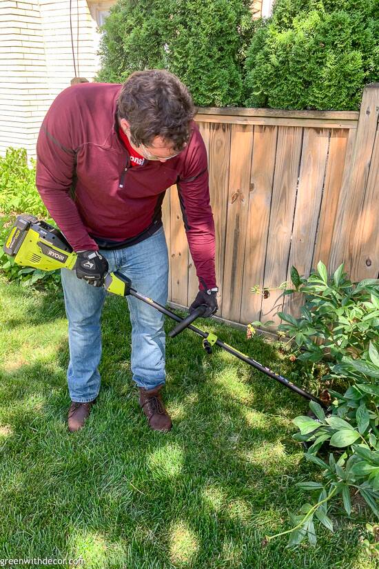 Guy using RYOBI string trimmer