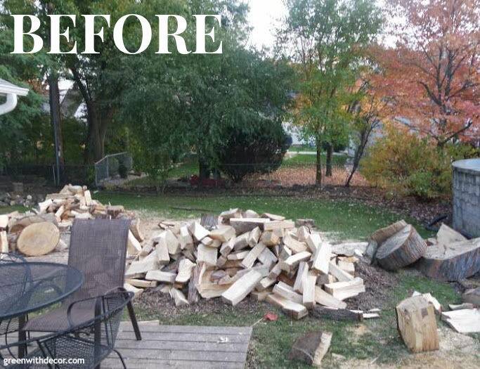 Backyard before shot with pile of wood and old deck