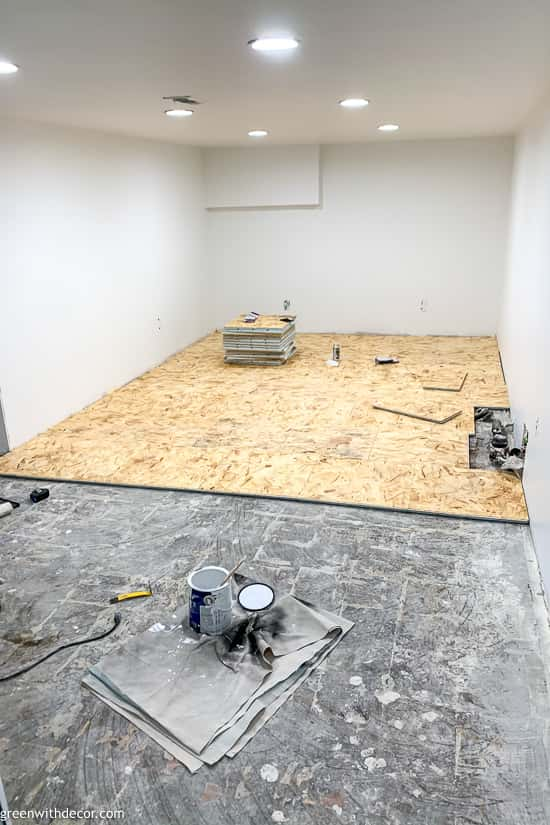 Subfloor partially installed in basement playroom