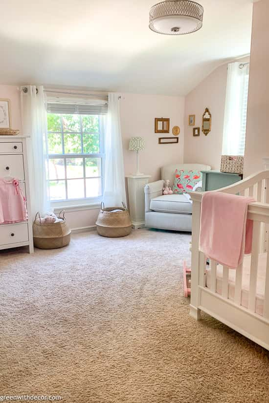 Girl's pink nursery with tan carpet