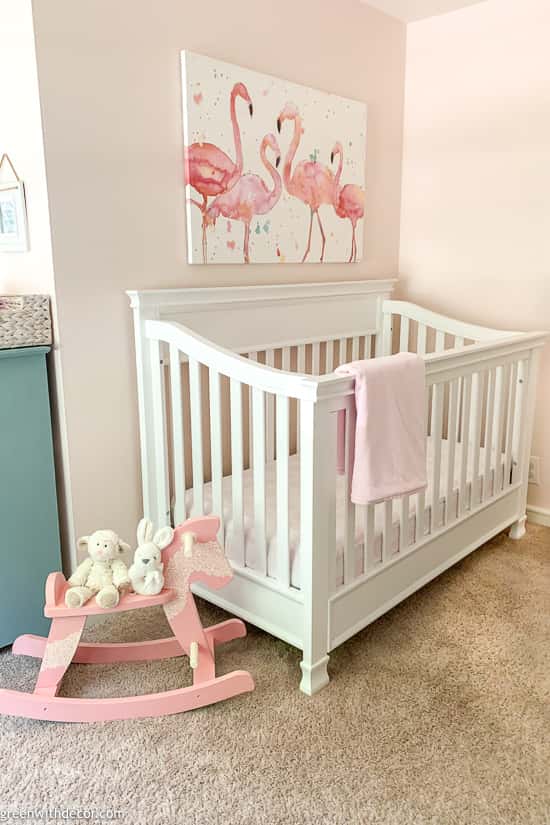 Pink girls nursery with white crib