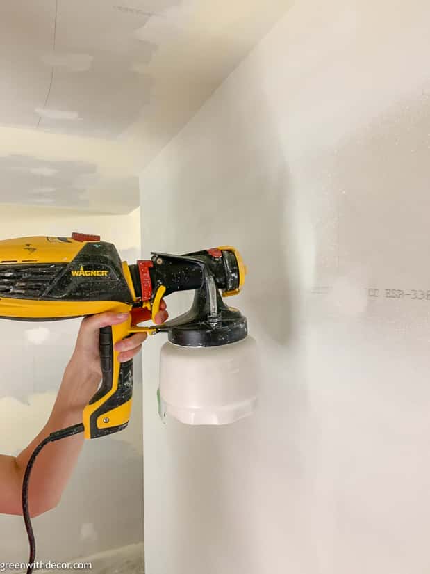 Painting a room with a paint sprayer