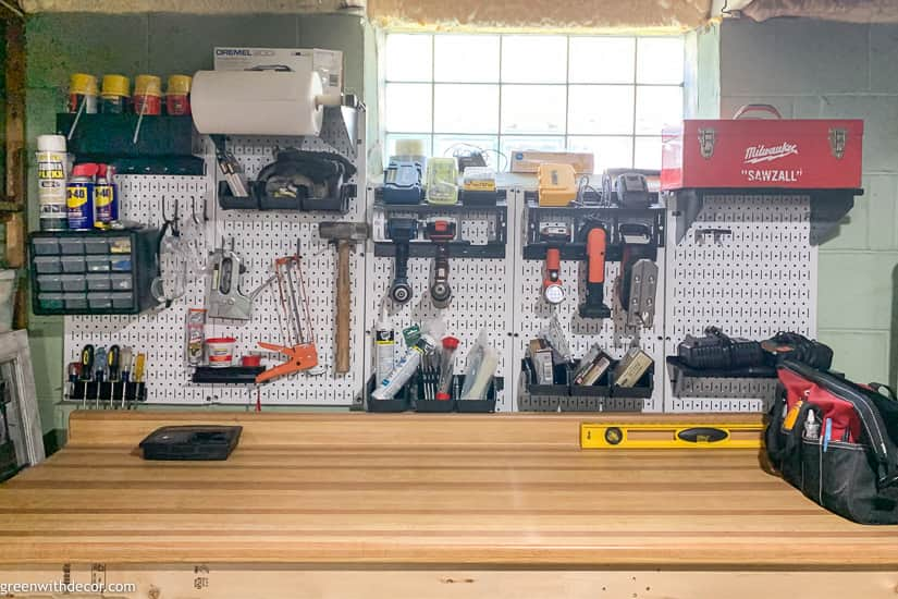 White pegboard tool organization near glass block window