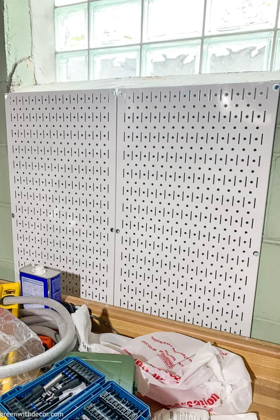 White pegboards installed to organize tools