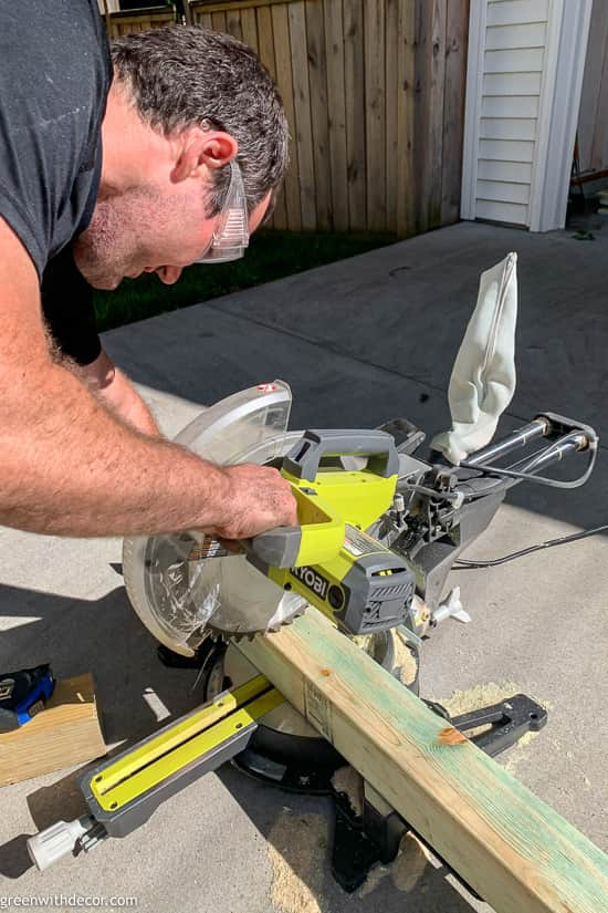 Guy cutting wood for DIY planter box