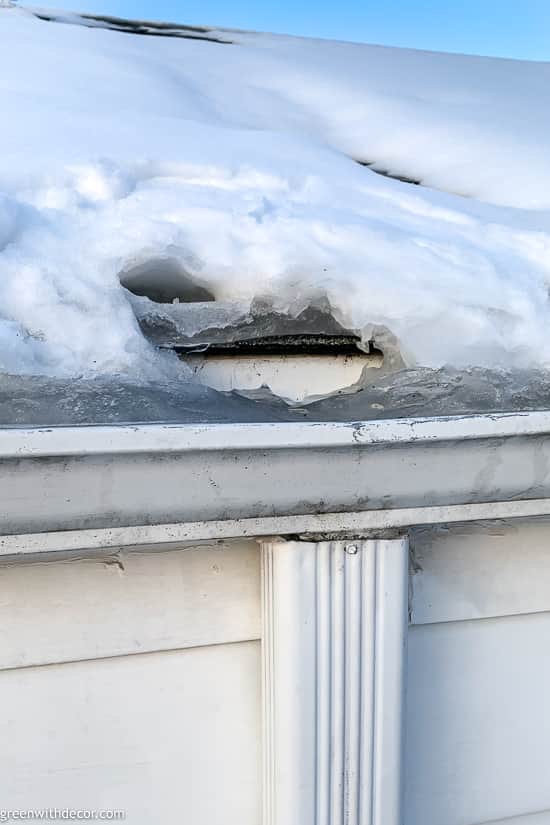 A thawed patch in the ice dam on a snowy roof