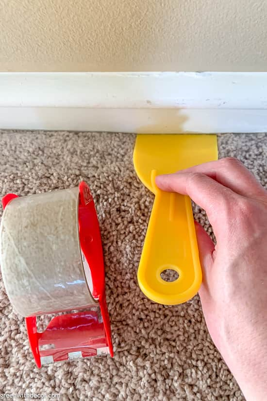 Putting tape down on carpet before painting trim