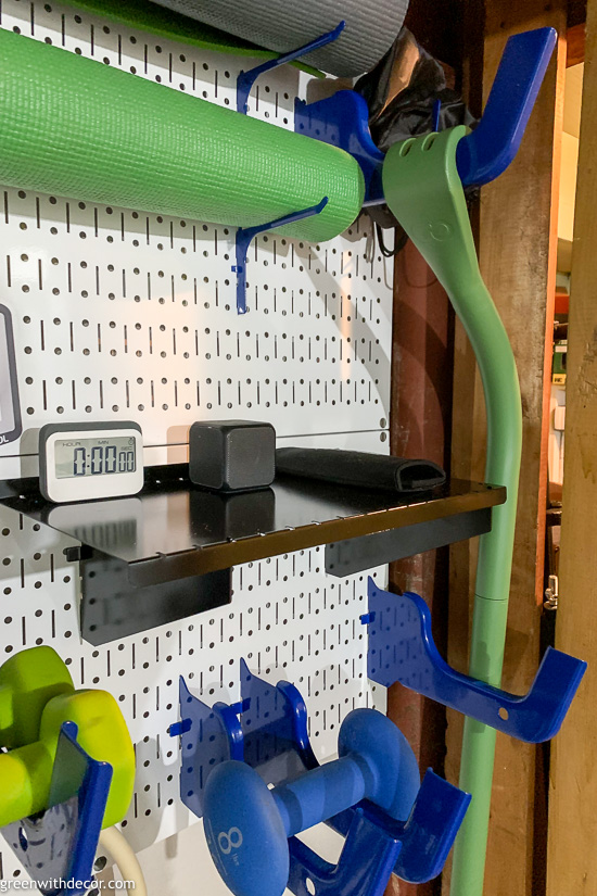 White pegboard with workout timer and speaker