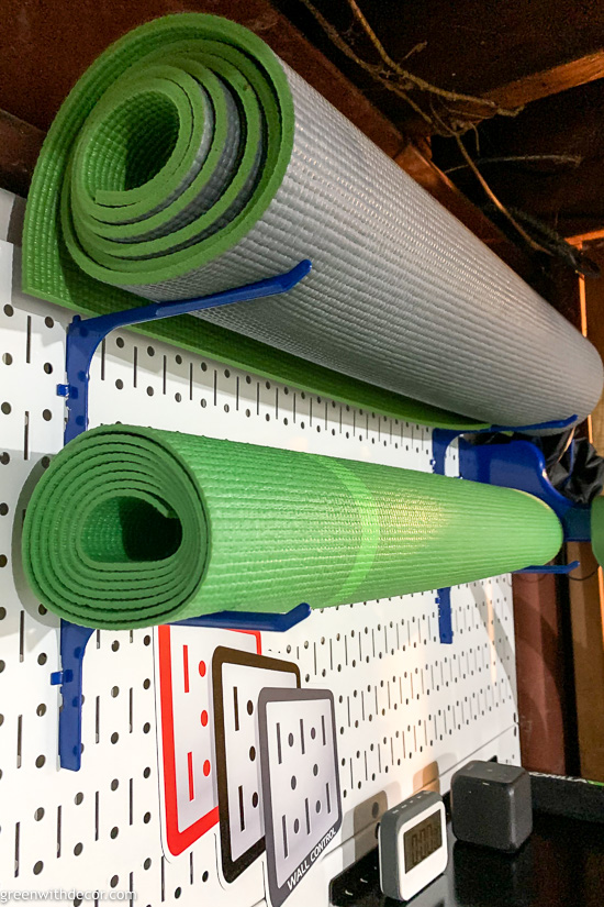 Use longer hooks to store yoga mats on pegboard